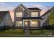 Charming two-story brick home with a fenced front yard and covered porch at 17021 Malone Ln, Mint Hill, NC 28227