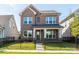 Charming two-story brick home with a fenced front yard and covered porch at 17021 Malone Ln, Mint Hill, NC 28227