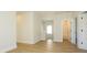 Bright hallway featuring wood floors, access to a bathroom, and a stairway leading to another level at 17021 Malone Ln, Mint Hill, NC 28227