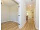 Hallway with hardwood floors leads to a bright space; neutral walls create a fresh look at 17021 Malone Ln, Mint Hill, NC 28227