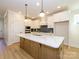 Bright kitchen featuring an island, white cabinets, modern backsplash, and pendant lights at 17021 Malone Ln, Mint Hill, NC 28227