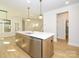 Kitchen island featuring a sink, dishwasher, wood cabinets, and pendant lighting at 17021 Malone Ln, Mint Hill, NC 28227