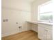 Bright laundry room featuring a built-in counter and storage cabinets for convenience at 17021 Malone Ln, Mint Hill, NC 28227