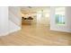 Open floorplan showcasing hardwood floors, kitchen, and natural light-filled living area at 17021 Malone Ln, Mint Hill, NC 28227