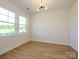 Bright living room with large windows, recessed lighting, and hardwood flooring at 17021 Malone Ln, Mint Hill, NC 28227