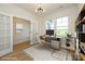 A bright office space with large windows, modern desk, chair, and decorative rug at 17021 Malone Ln, Mint Hill, NC 28227