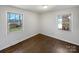 Bedroom featuring hardwood floors, neutral paint and two windows providing natural light at 207 Bright Ave, Bessemer City, NC 28016