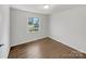 Bright, empty bedroom with hardwood floors and a large window offering a view of the outdoors at 207 Bright Ave, Bessemer City, NC 28016