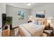 Staged bedroom featuring a window view, a bed with neutral linens, and modern décor at 207 Bright Ave, Bessemer City, NC 28016