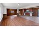 Spacious open-concept living area with hardwood floors flowing into the adjacent dining area and kitchen at 207 Bright Ave, Bessemer City, NC 28016