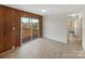Bright living room with sliding door access to a private deck and a view of the surrounding trees at 207 Bright Ave, Bessemer City, NC 28016