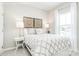 Bright bedroom featuring a white-framed bed with patterned bedding, side tables, and window with natural light at 2159 Primm Farms Dr # C, Charlotte, NC 28216