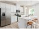 Bright kitchen features white cabinets, stainless appliances and island seating at 2159 Primm Farms Dr # C, Charlotte, NC 28216