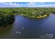 Aerial view of the scenic lake, surrounded by lush trees, with docks and paddleboarders at 2159 Primm Farms Dr # C, Charlotte, NC 28216