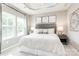 Calm main bedroom with tray ceiling, large bed, and lots of light at 2159 Primm Farms Dr # C, Charlotte, NC 28216