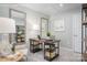 Chic office space featuring a desk, comfortable chair, shelving, neutral color palette, and mirrors at 2159 Primm Farms Dr # C, Charlotte, NC 28216