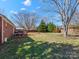 Large backyard features a deck, mature trees, and a well-maintained lawn at 3204 Starrland Dr, Gastonia, NC 28052