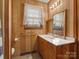 Bathroom features wood paneling, a vanity, and a window at 3204 Starrland Dr, Gastonia, NC 28052