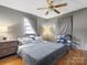 Comfortable bedroom features a ceiling fan, hardwood floors, and curtains at 3204 Starrland Dr, Gastonia, NC 28052
