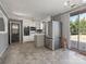 Open kitchen with white cabinets, stainless steel appliances, and access to the backyard at 3204 Starrland Dr, Gastonia, NC 28052