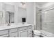 Bright bathroom featuring double sinks, white cabinets, and a glass-enclosed tiled shower at 3308 Timber Mill Dr, Stallings, NC 28104