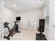 Bright exercise room with neutral carpet, Peloton stationary bike, weight machine, and natural light from the window at 3308 Timber Mill Dr, Stallings, NC 28104
