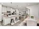 Bright, open kitchen with stainless steel appliances and an island with bar stool seating at 3308 Timber Mill Dr, Stallings, NC 28104