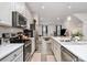 Modern kitchen featuring stainless steel appliances, a subway tile backsplash, and abundant counter space at 3308 Timber Mill Dr, Stallings, NC 28104