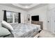Serene main bedroom with tray ceiling, a large window and a wooden dresser at 3308 Timber Mill Dr, Stallings, NC 28104