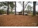 Backyard of home with outbuildings and tall trees at 351 York Spann Rd, Hamptonville, NC 27020