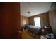 Bedroom with wood paneling, vintage carpet, and a cozy bed, providing a private and restful space at 351 York Spann Rd, Hamptonville, NC 27020