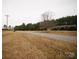 Property view of a home on a grassy lot with a tree line, offering space and privacy at 351 York Spann Rd, Hamptonville, NC 27020
