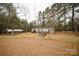 Charming single story home with a front yard, complemented by carport and natural surroundings at 351 York Spann Rd, Hamptonville, NC 27020