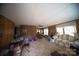 Cozy living room with wood paneling, vintage furnishings, and ample natural light, offering a comfortable living space at 351 York Spann Rd, Hamptonville, NC 27020