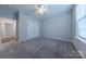 Large bedroom with carpet, ceiling fan, double door closet, and large window at 3614 Monastic Rd, Indian Land, SC 29707