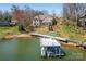 Gorgeous lakefront home featuring mature trees, stone steps, and a private boat dock at 4164 54Th Ne Ave, Hickory, NC 28601