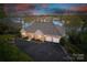 Aerial view of brick home with an attached three-car garage, a circular driveway, and lush landscaping at 4164 54Th Ne Ave, Hickory, NC 28601