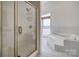 Contemporary bathroom featuring a glass-enclosed shower and a soaking tub by the window at 4164 54Th Ne Ave, Hickory, NC 28601