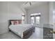 Bright bedroom with white walls, wood-look tile flooring, and a patio door to let natural light in at 4164 54Th Ne Ave, Hickory, NC 28601