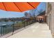 Relax on the expansive deck with an orange umbrella, perfect for enjoying waterfront views and outdoor dining at 4164 54Th Ne Ave, Hickory, NC 28601