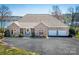 Beautiful brick home with well-manicured lawn, mature trees, and an attached three-car garage at 4164 54Th Ne Ave, Hickory, NC 28601