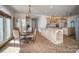 Open kitchen and dining area featuring custom cabinets, granite countertops, a kitchen island, and stainless steel appliances at 4164 54Th Ne Ave, Hickory, NC 28601