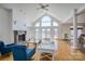 Bright living room with hardwood floors, a fireplace, large windows, and French doors that offer stunning lake views at 4164 54Th Ne Ave, Hickory, NC 28601