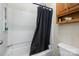 Bathroom featuring a shower/tub combination with black shower curtain and built-in shelving at 4400 Sharon Chase Dr, Charlotte, NC 28215