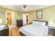 Comfortable bedroom featuring wood-look floors, ceiling fan, and ensuite bathroom at 706 Skinner Rd, Shelby, NC 28152