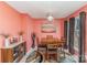 Inviting dining area features a wooden table, decorative lighting, and a sunset wall art piece at 706 Skinner Rd, Shelby, NC 28152