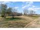 View of the single story home surrounded by mature trees and a large yard at 706 Skinner Rd, Shelby, NC 28152