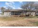 Back exterior view featuring a screened-in porch, lush green grass, and well-maintained landscaping at 706 Skinner Rd, Shelby, NC 28152