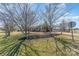 Landscaped front yard featuring single story home, mature trees and mulch beds at 706 Skinner Rd, Shelby, NC 28152