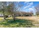 Single story home surrounded by mature trees on a manicured lawn at 706 Skinner Rd, Shelby, NC 28152